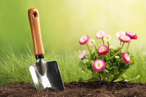 Trained gardener using tools with proper safety measures